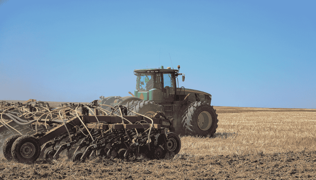 Delayed Seeding image 1 seeding equipment and tractor in field